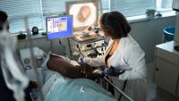 Mature doctor doing an endoscopy exam in patient.
